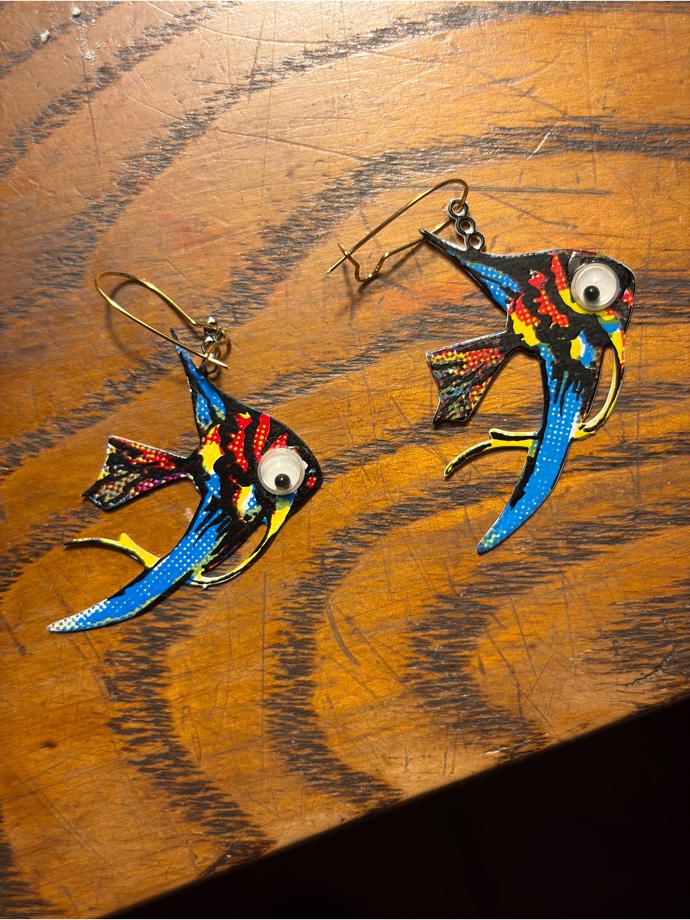 earrings feature colorful enamel-painted tropical fish charms with googly eyes